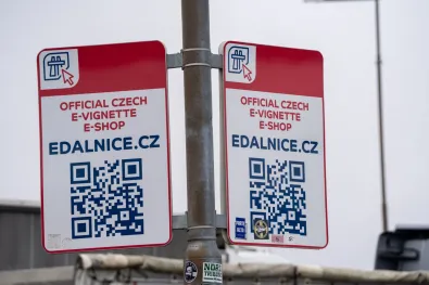 Official Czech e-vignette e-shop sign for edalnice.cz with QR code at a One1 petrol station near the Rozvadov border crossing, captured on February 25, 2026